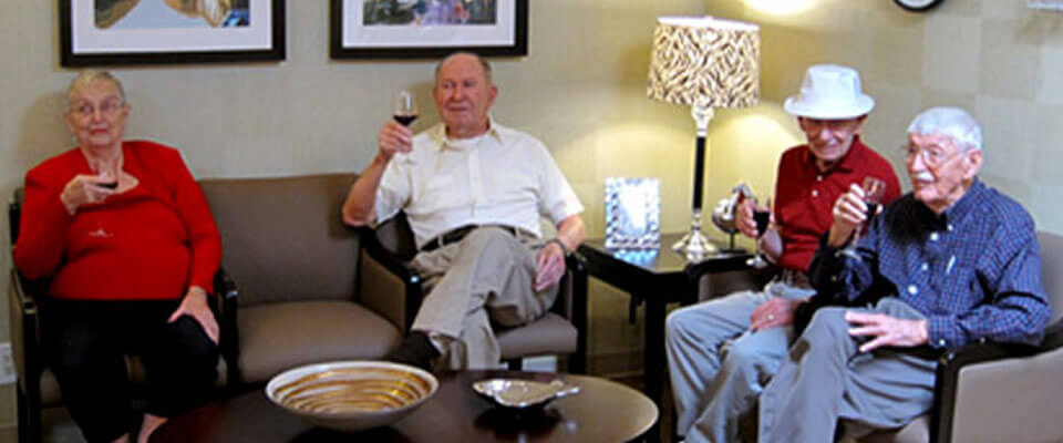 Seniors enjoying drinks in a common area.