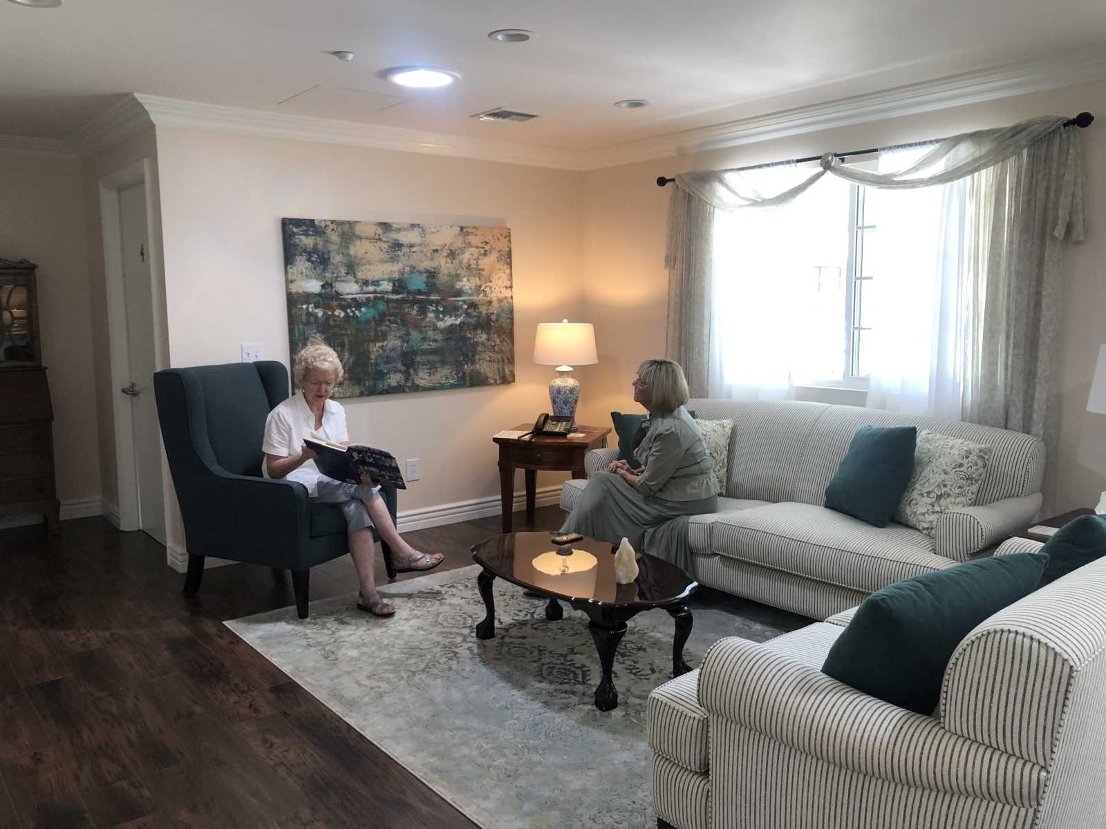 Residents socializing in a cozy living room area.