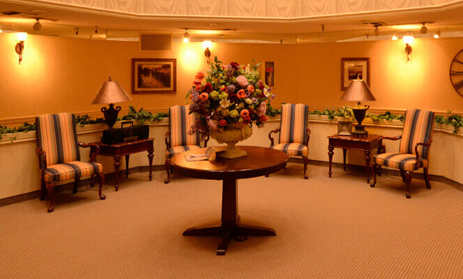 Interior common area with floral arrangement and seating.