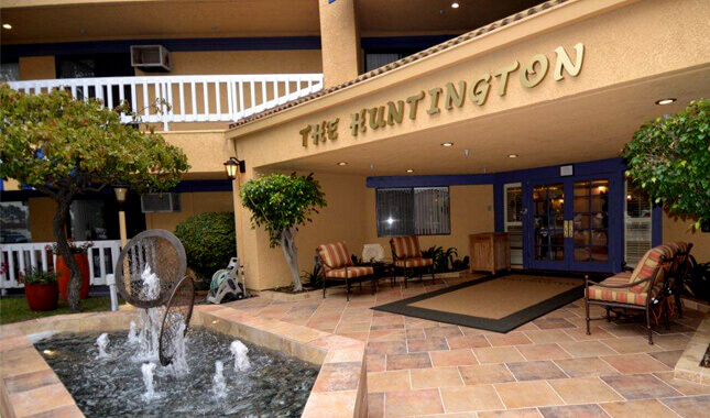 Front entrance of The Huntington with seating and fountain.