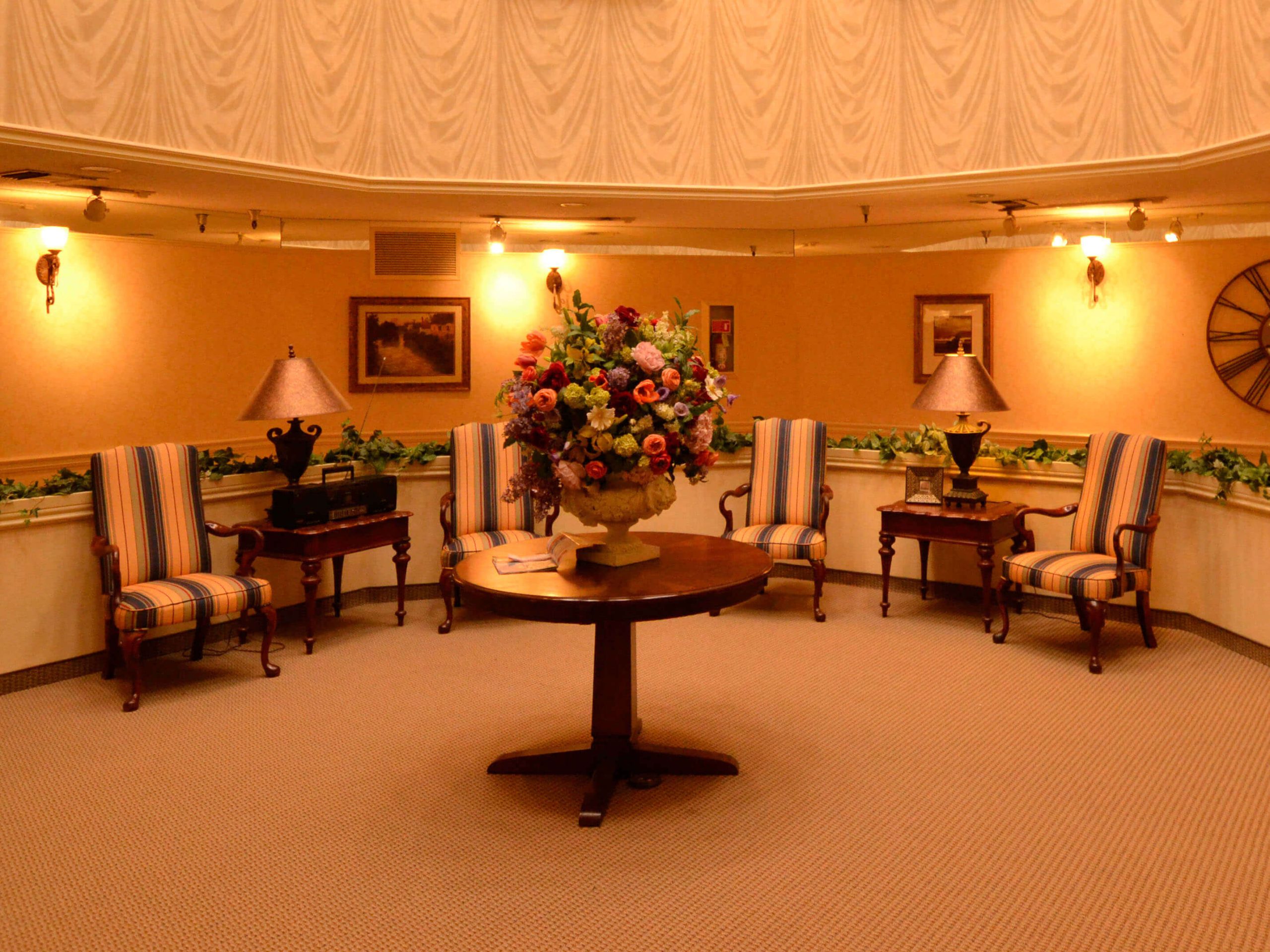 Cozy common area with seating and floral decor.