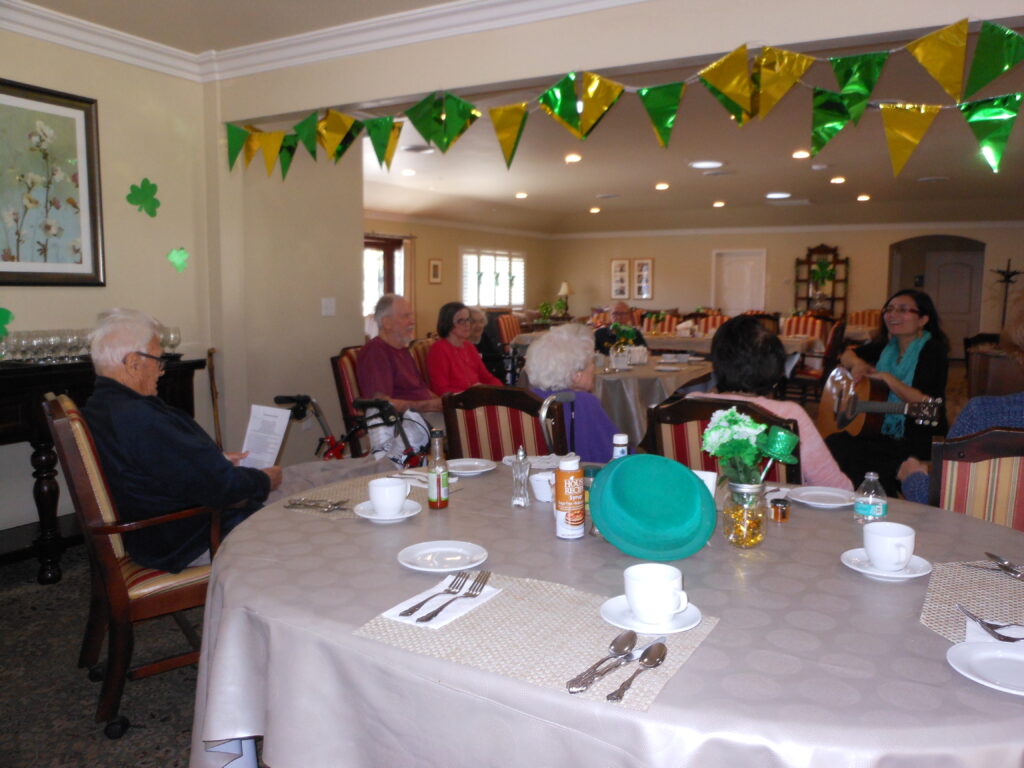 Residents enjoying a musical performance in a common area.