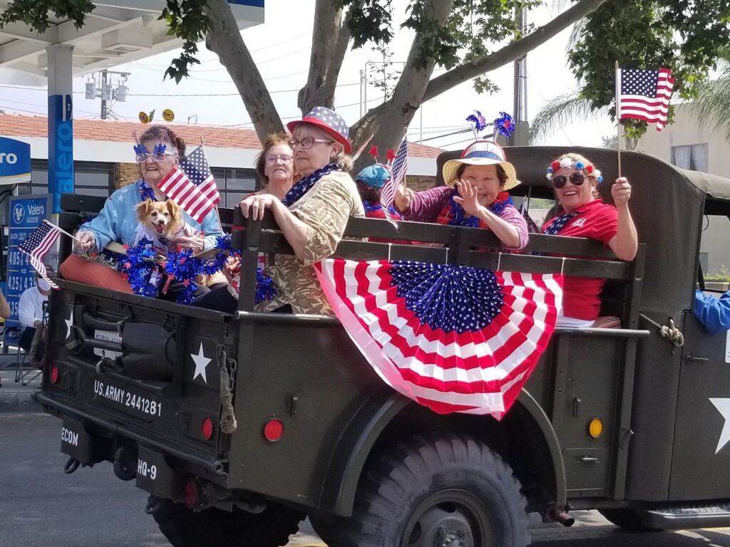 Residents celebrating in a decorated military vehicle