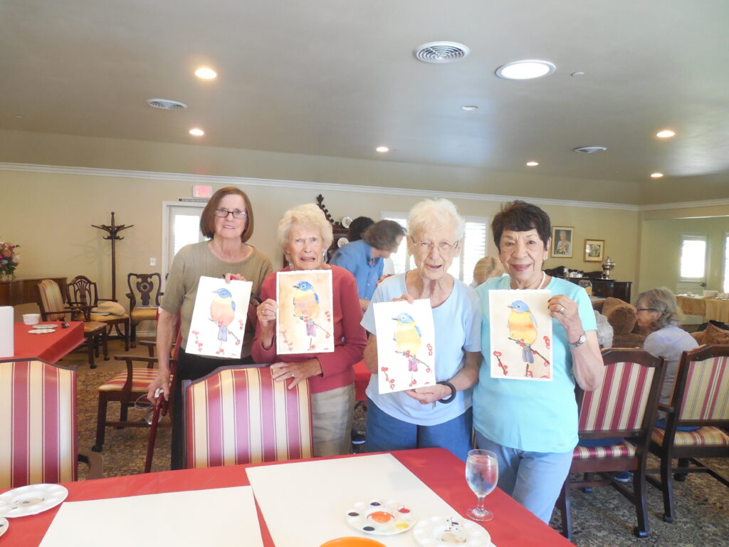 Residents participate in an art activity displaying their artwork.