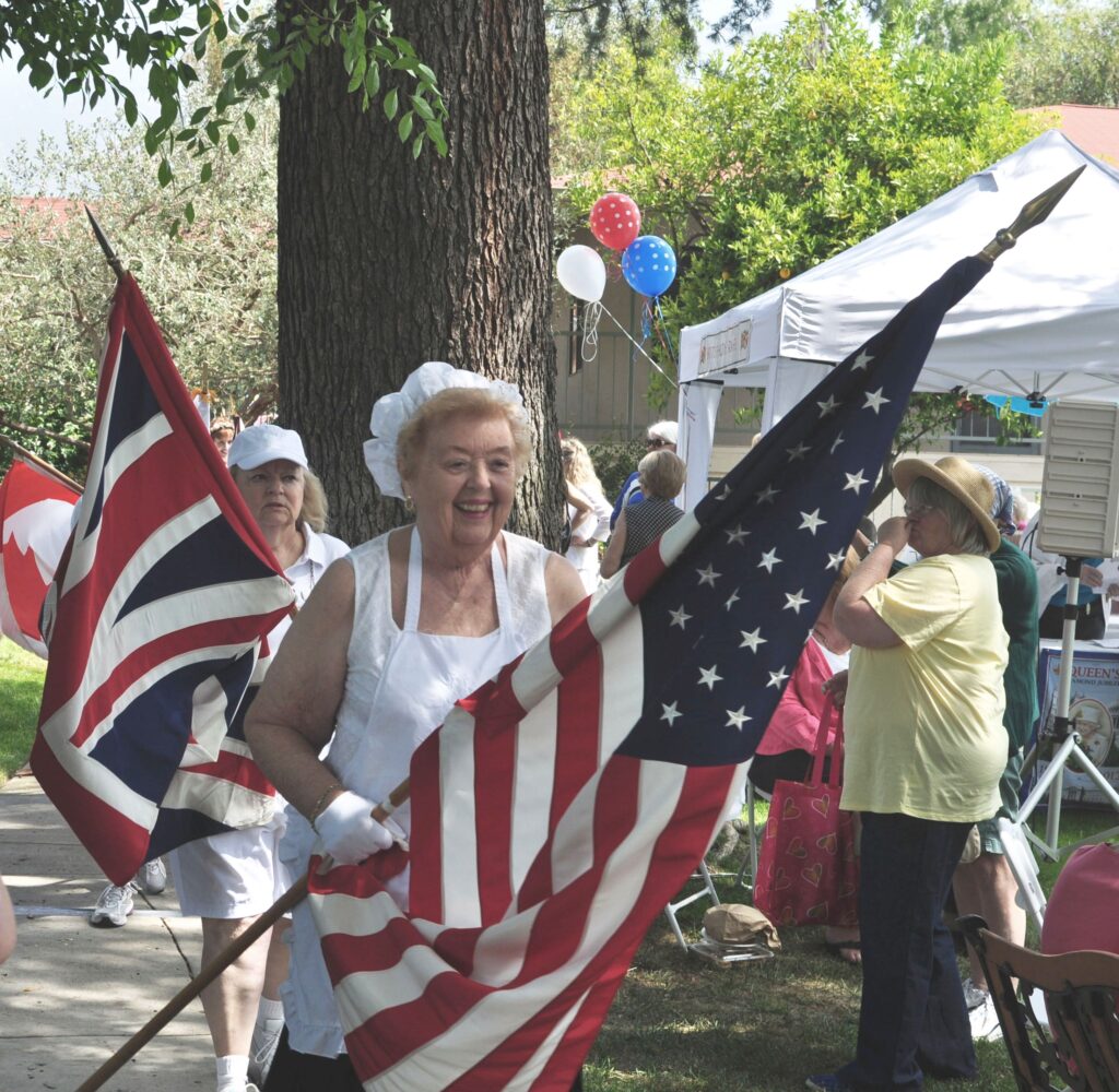Residents celebrating with flags outdoors