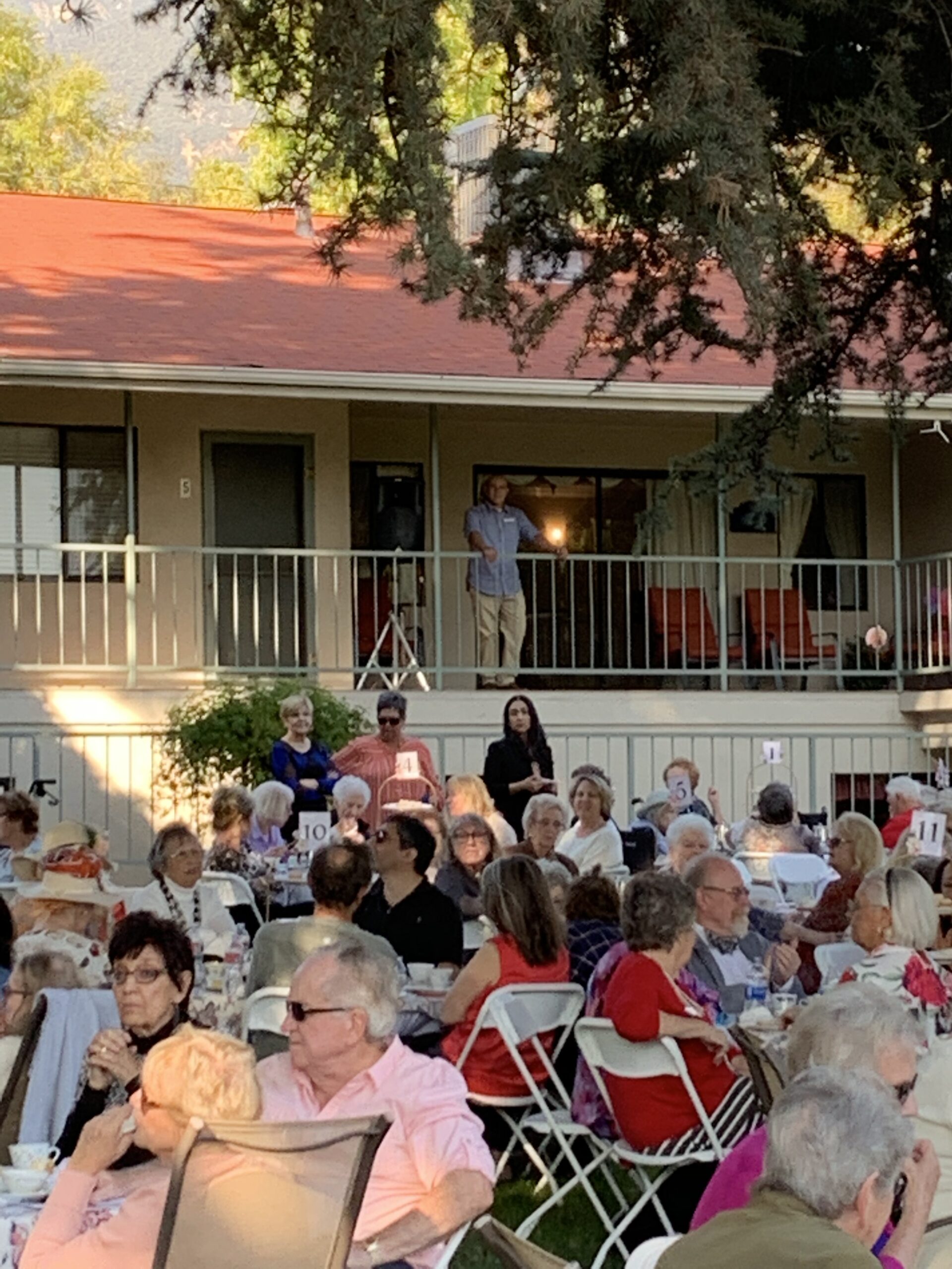 Outdoor gathering of residents enjoying an event.