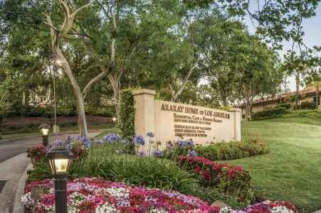 Signage with flowers representing Ararat Home of Los Angeles