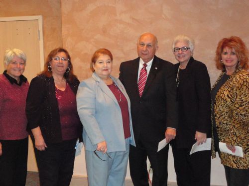 Group of people posing together at an event.