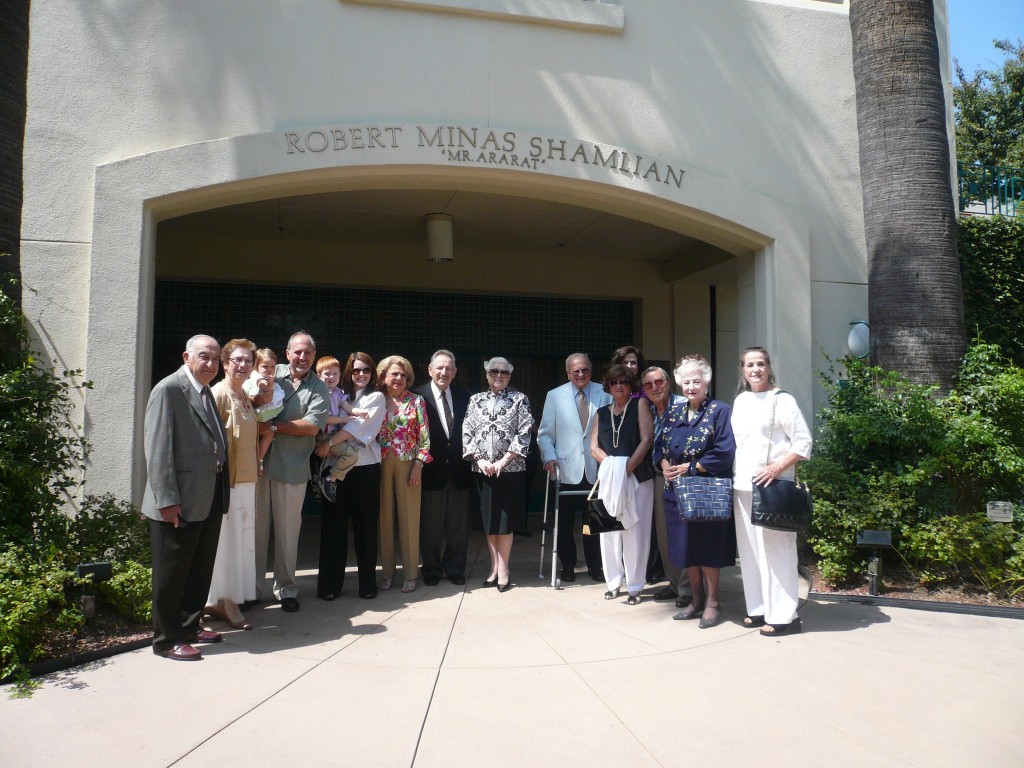 Group of people gathered outside the facility entrance.