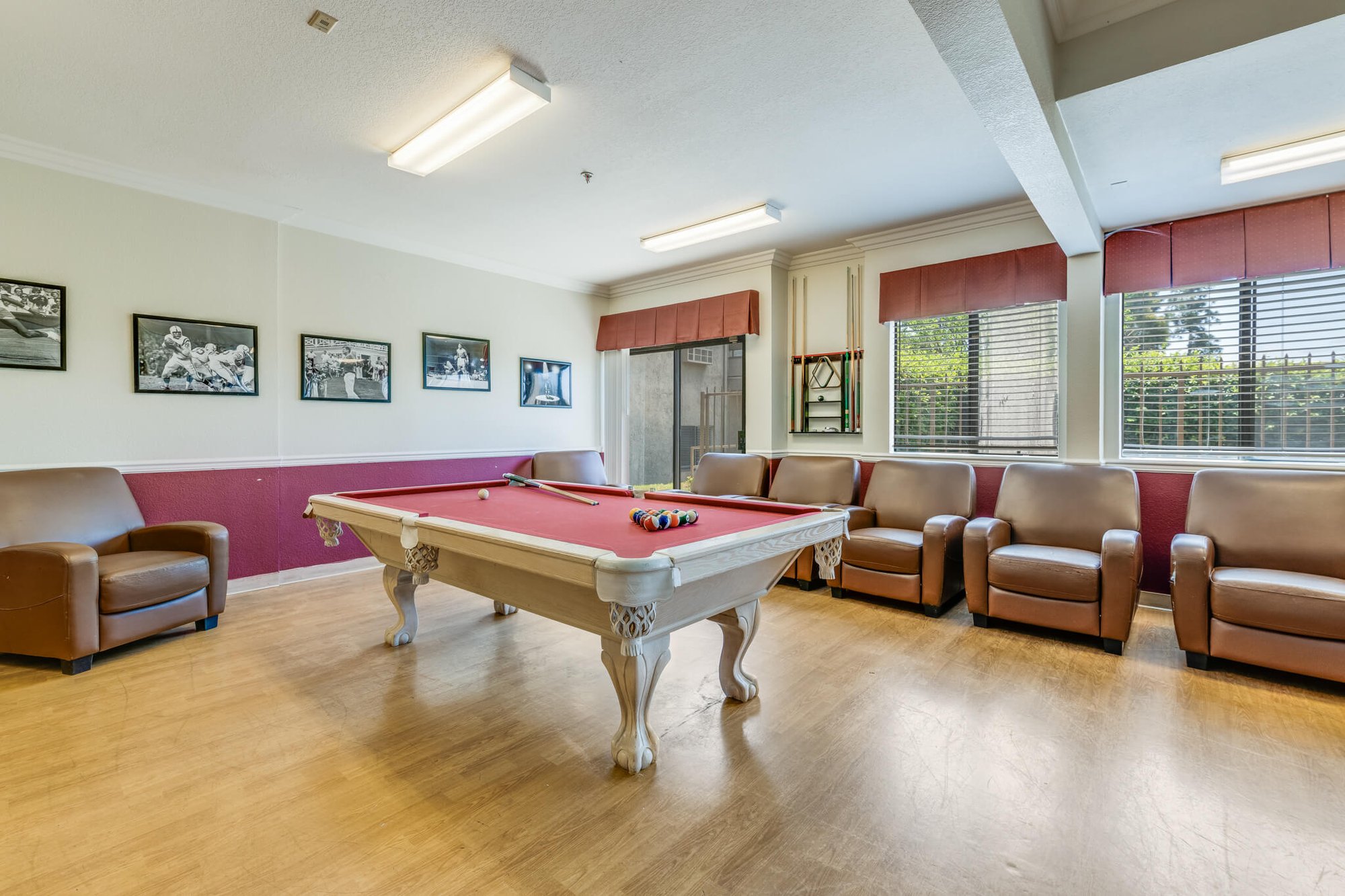 Common area with a pool table and seating.