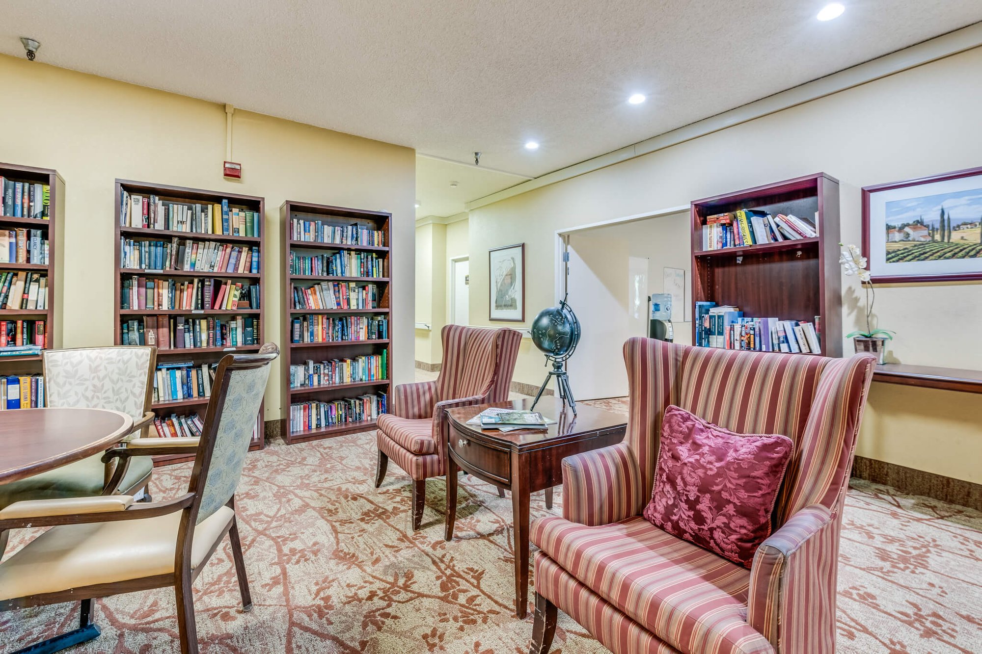 Interior view of a cozy reading area with bookshelves.