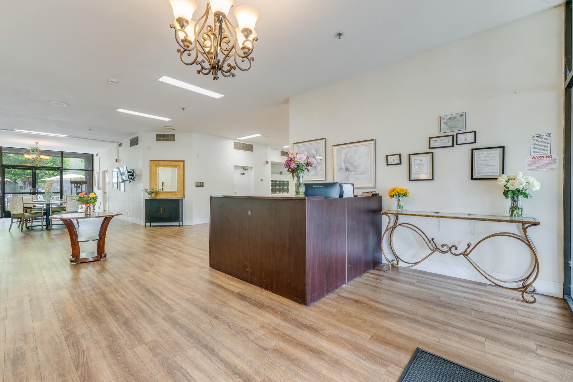 Welcoming lobby area with reception desk and floral arrangements.