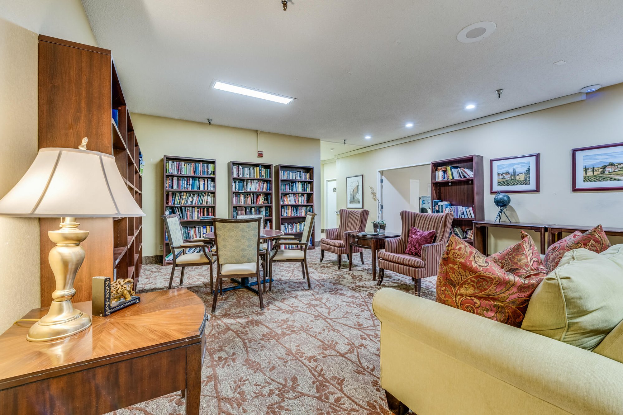 Cozy common area with bookshelves and seating.