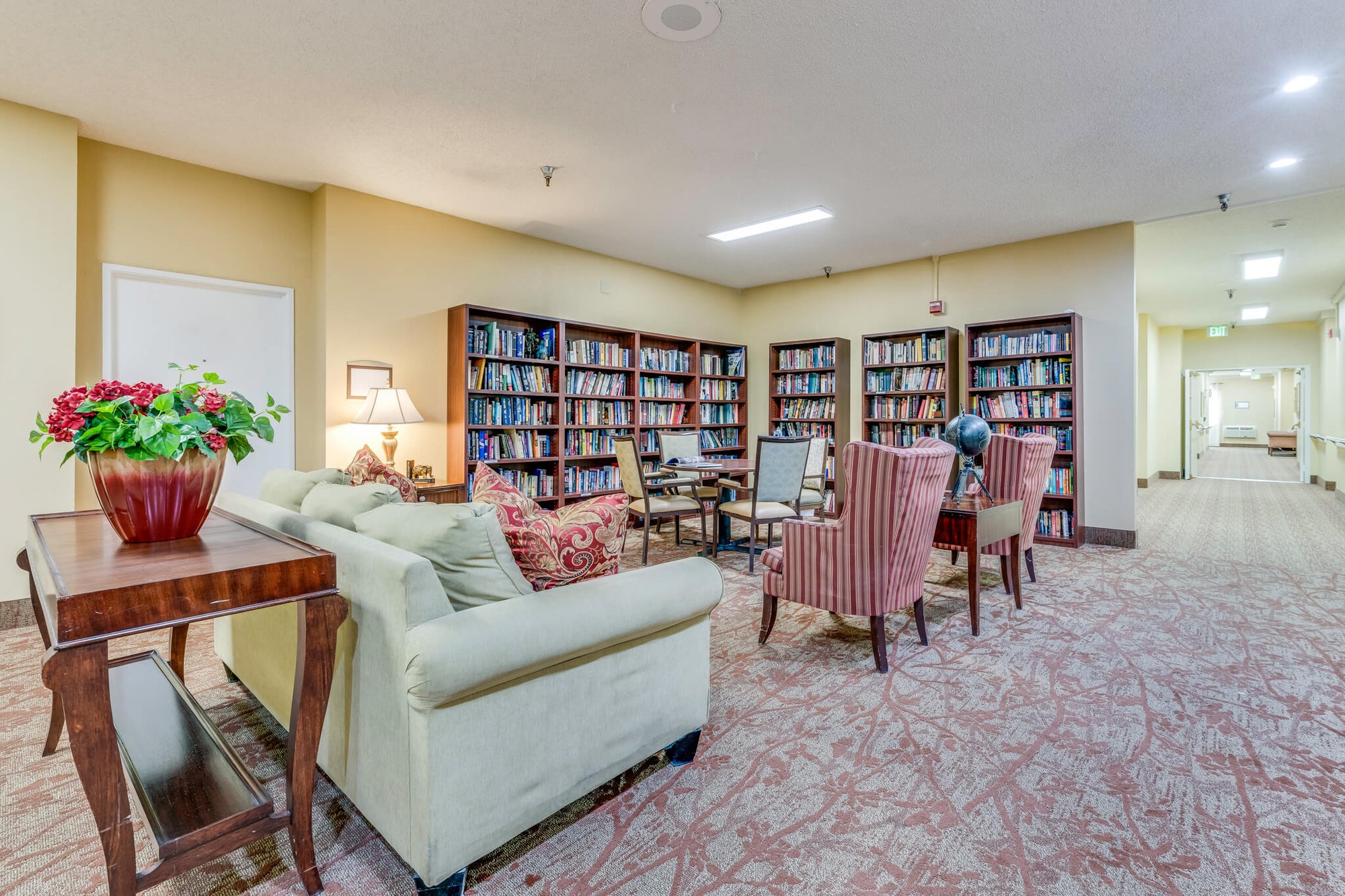 Cozy common area with bookshelves and seating.