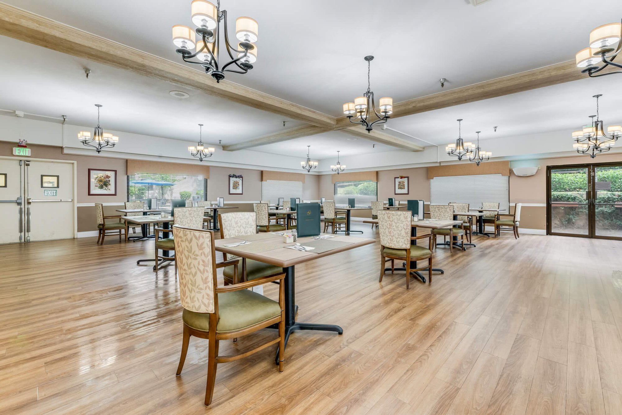 Dining room with tables and chairs for residents.