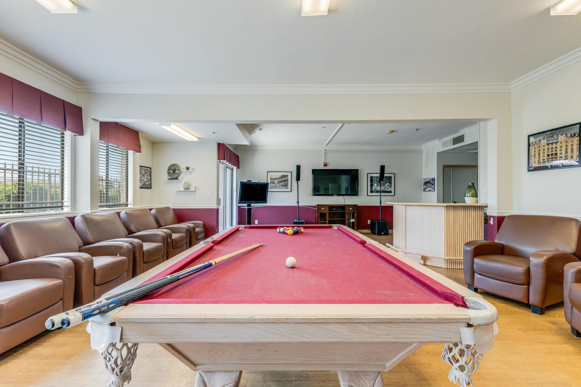 Billiards table with seating area in the common room.