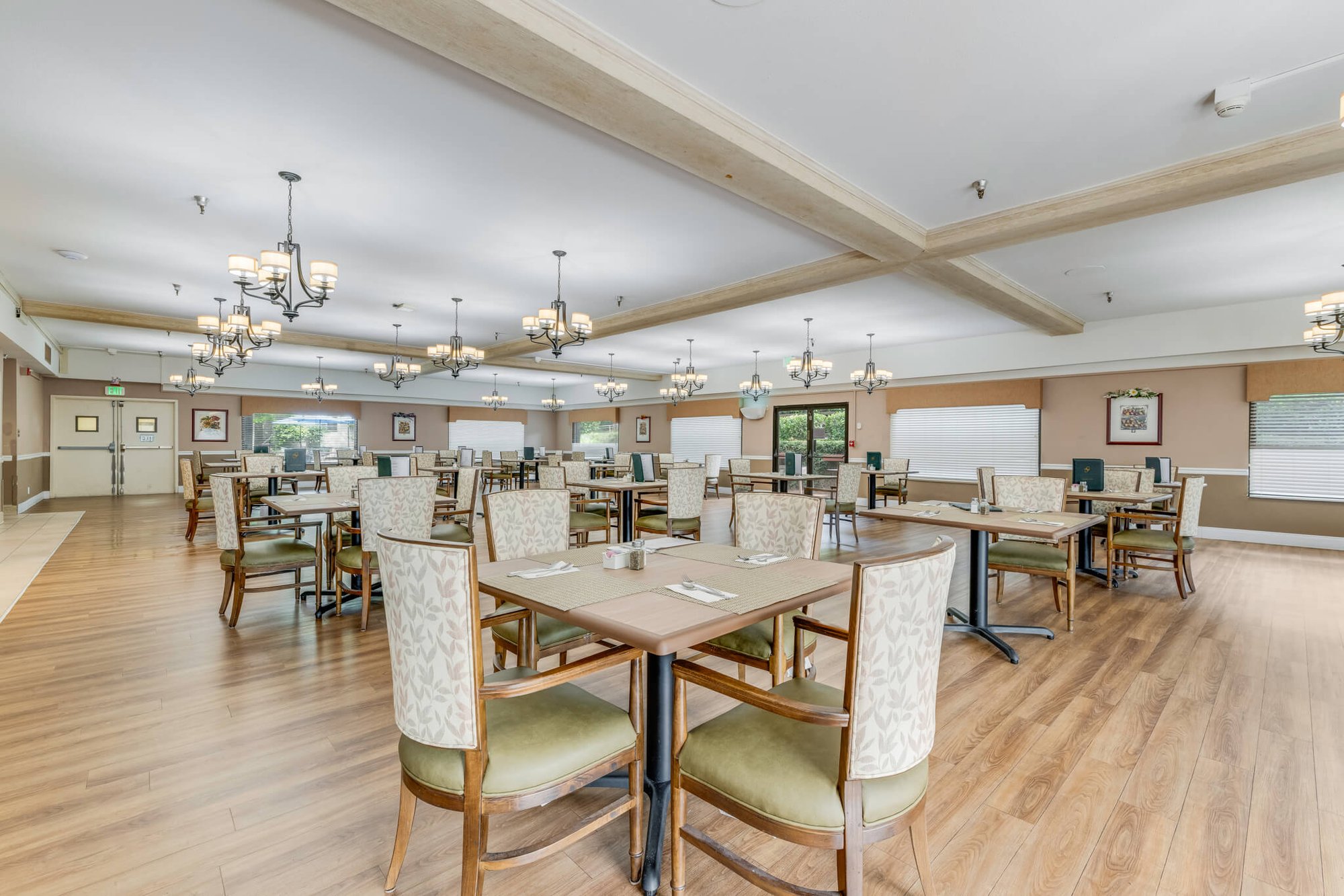 Spacious dining room with tables and chairs.