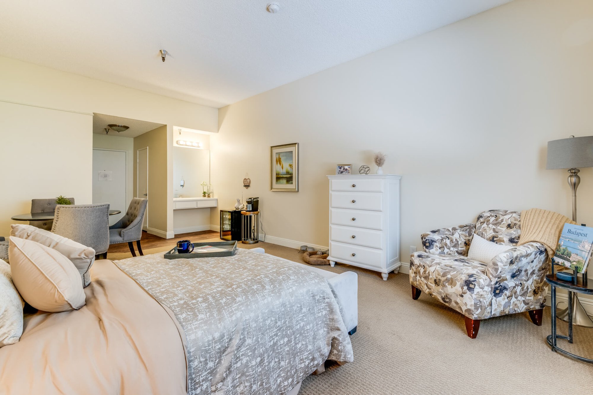 Cozy bedroom setup with a chair and dresser.