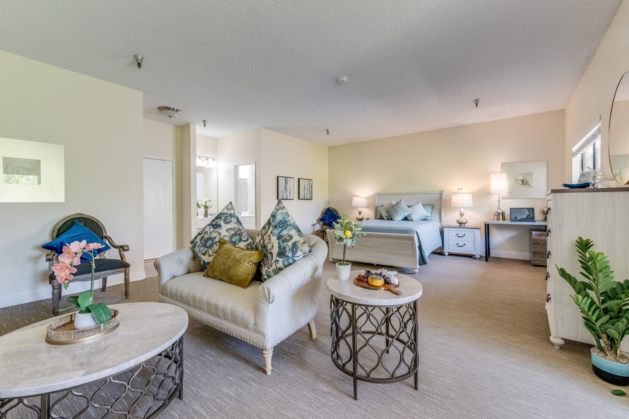 Bright, welcoming resident room with comfortable furnishings.