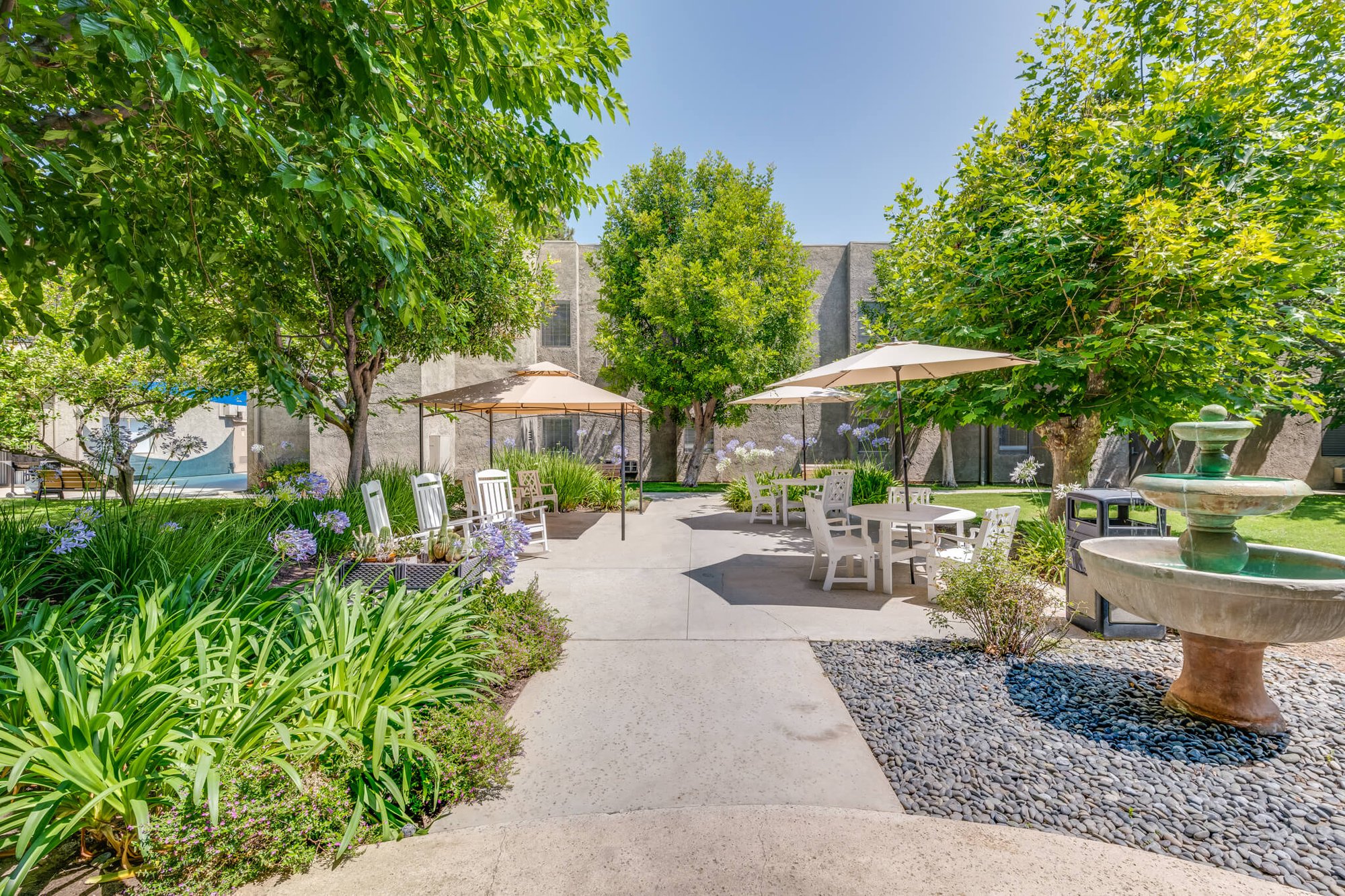 Serene outdoor garden area with seating and fountain
