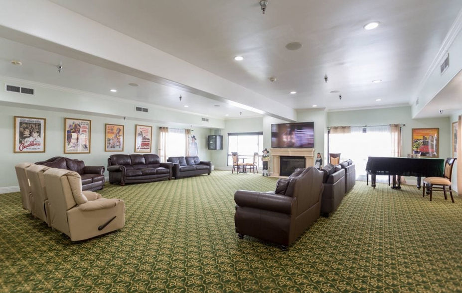 Spacious interior common area with seating and piano