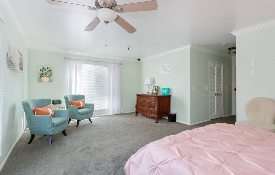 Bright and inviting resident room with furniture