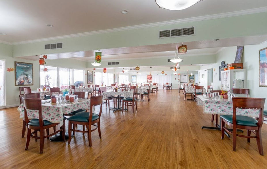 Dining room with decorated tables and wooden flooring