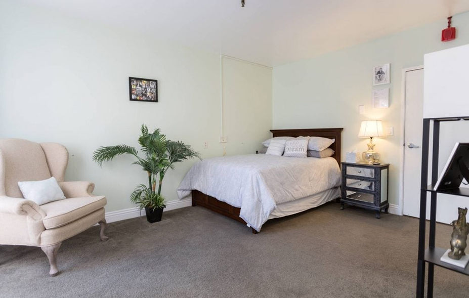 Cozy resident room with a bed and chair
