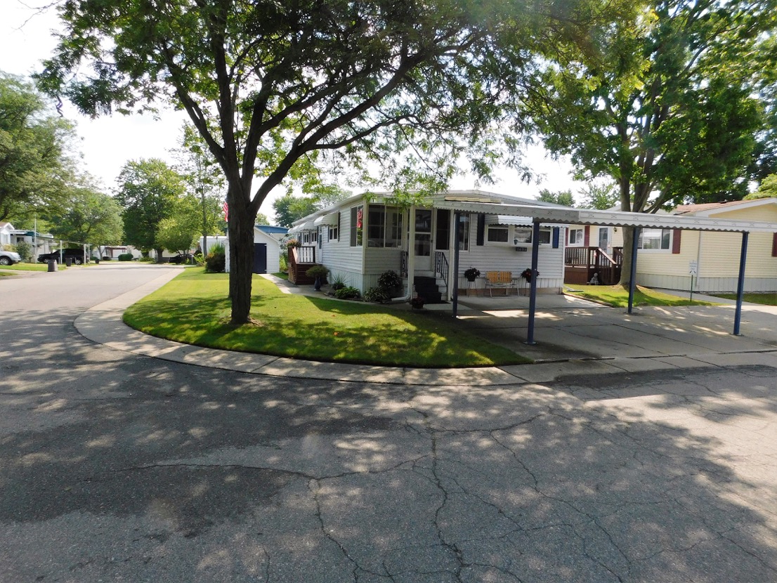 Exterior view of a community area with trees and pathway.