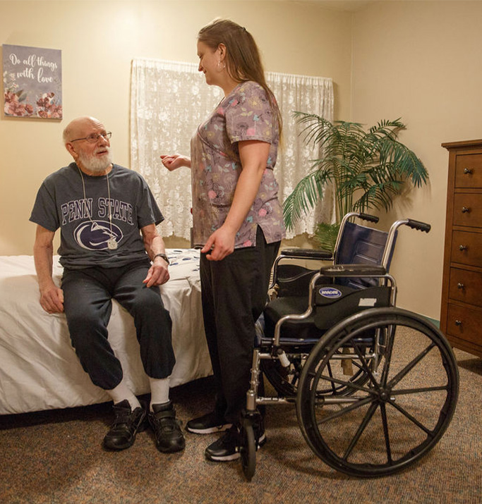 Staff member assisting resident in a room