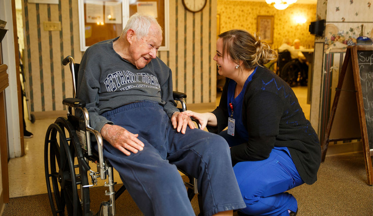 Staff member engaging with a resident in a common area