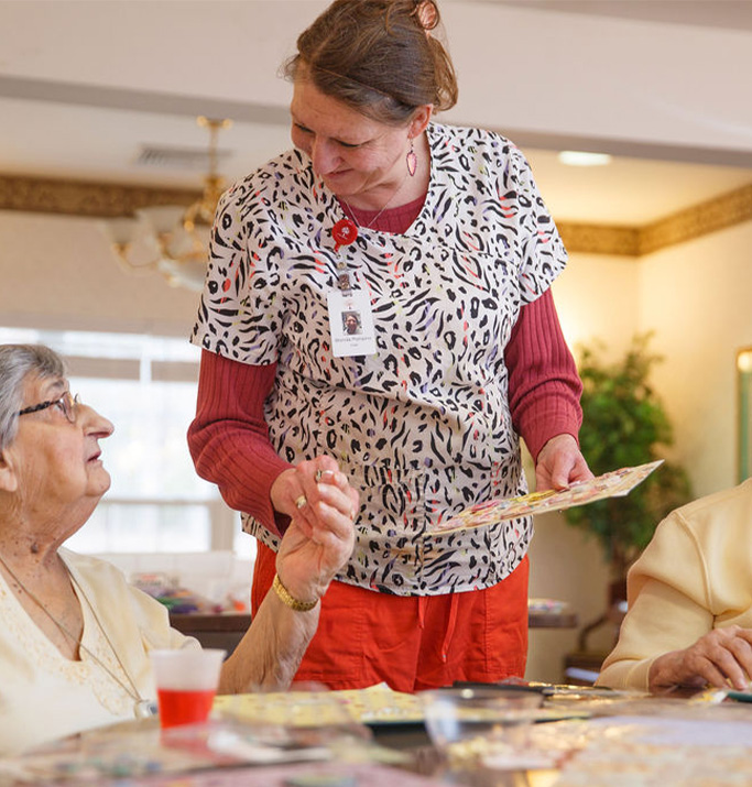 Staff member assisting residents with activities