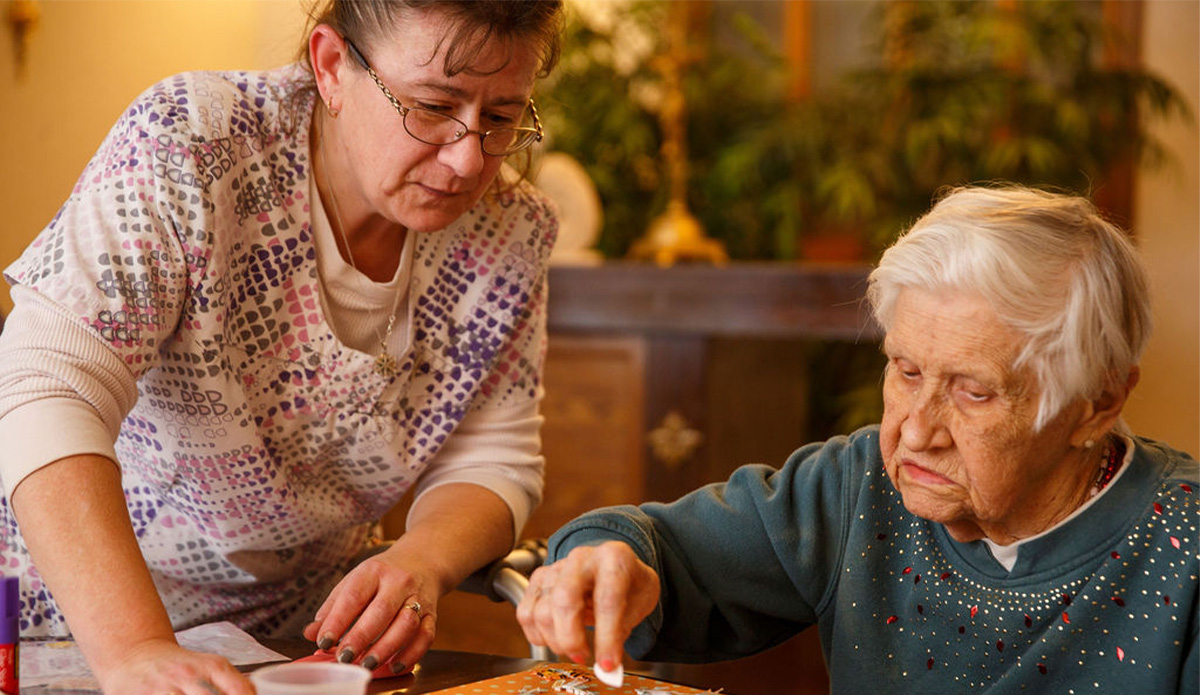Staff assisting a resident with an activity.