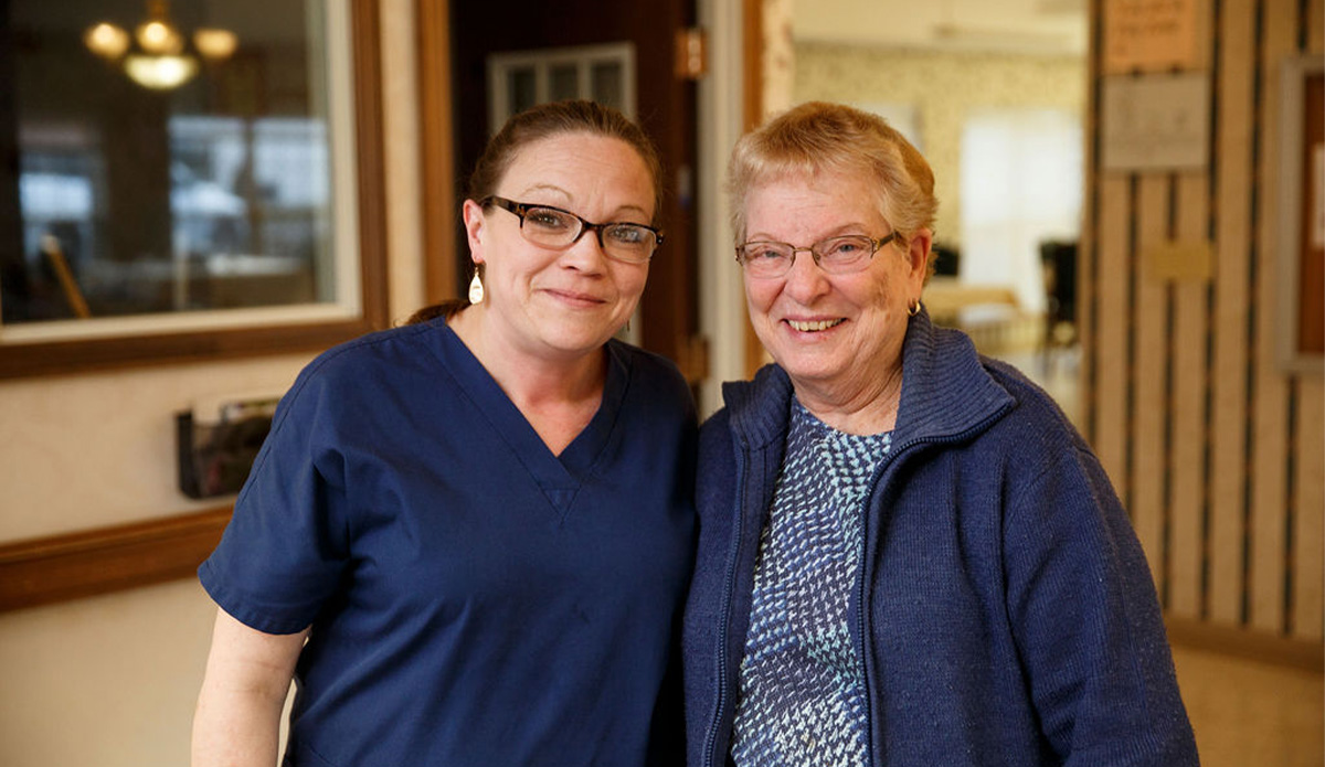 Staff member and resident smiling together
