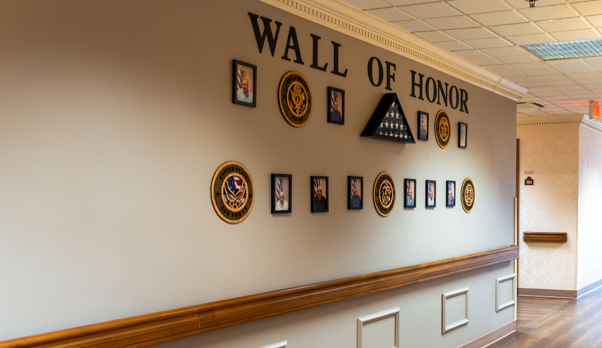 Wall of Honor displaying military photos and emblems