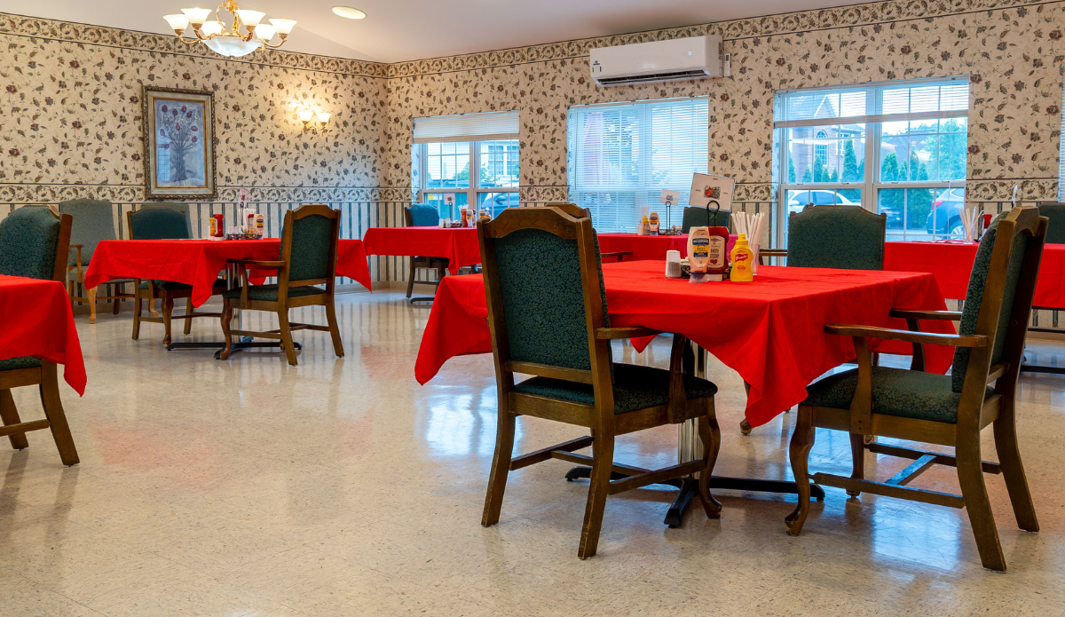 Dining area with red tables and green chairs