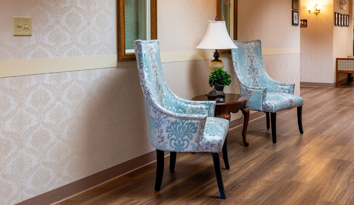 Seating area with two decorative chairs and a lamp