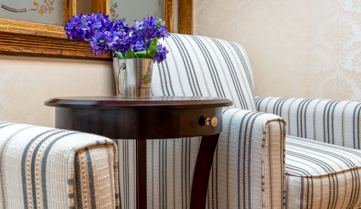 Cozy seating area with flowers and striped chairs