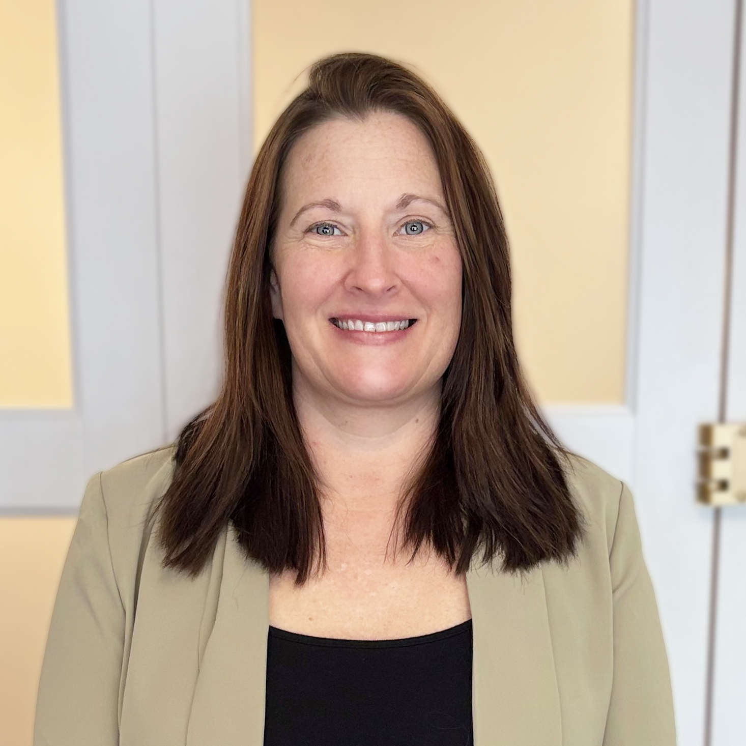 Staff member smiling in a professional setting.