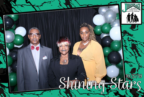 Three people posing at a festive event