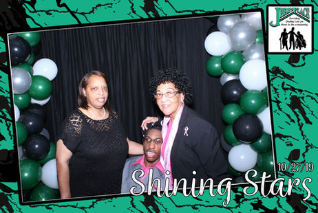 Three individuals celebrating at an event