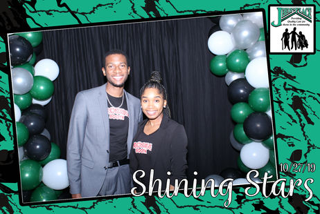 Two individuals at a decorated event with balloons