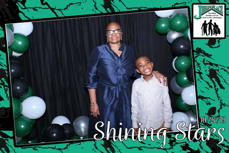 Two people posing together at an event