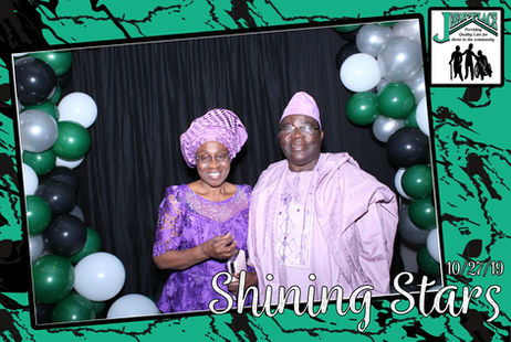 Two people celebrating at an event with decorations.