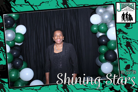 Resident posing at a celebratory event with decorations