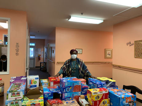 Staff member with food supplies in a common area