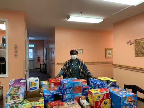 Staff member with a table of food items in the interior