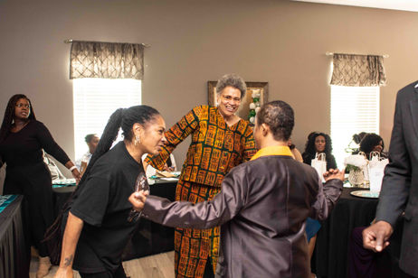 Residents dancing in a lively common area.