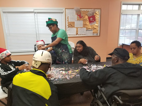 Residents and staff engage in a crafting activity.
