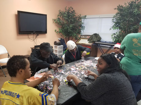 Residents and staff engaged in a craft activity.